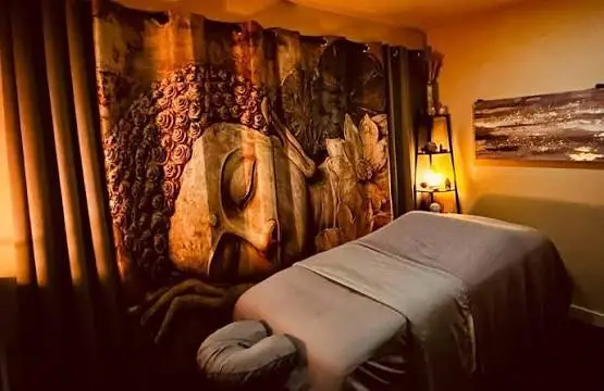 A massage table at Salt Cove Spa dressed with a patterned tapestry