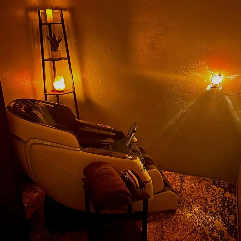 A warm, dimly lit room at Salt Cove Spa with a lit salt lamp